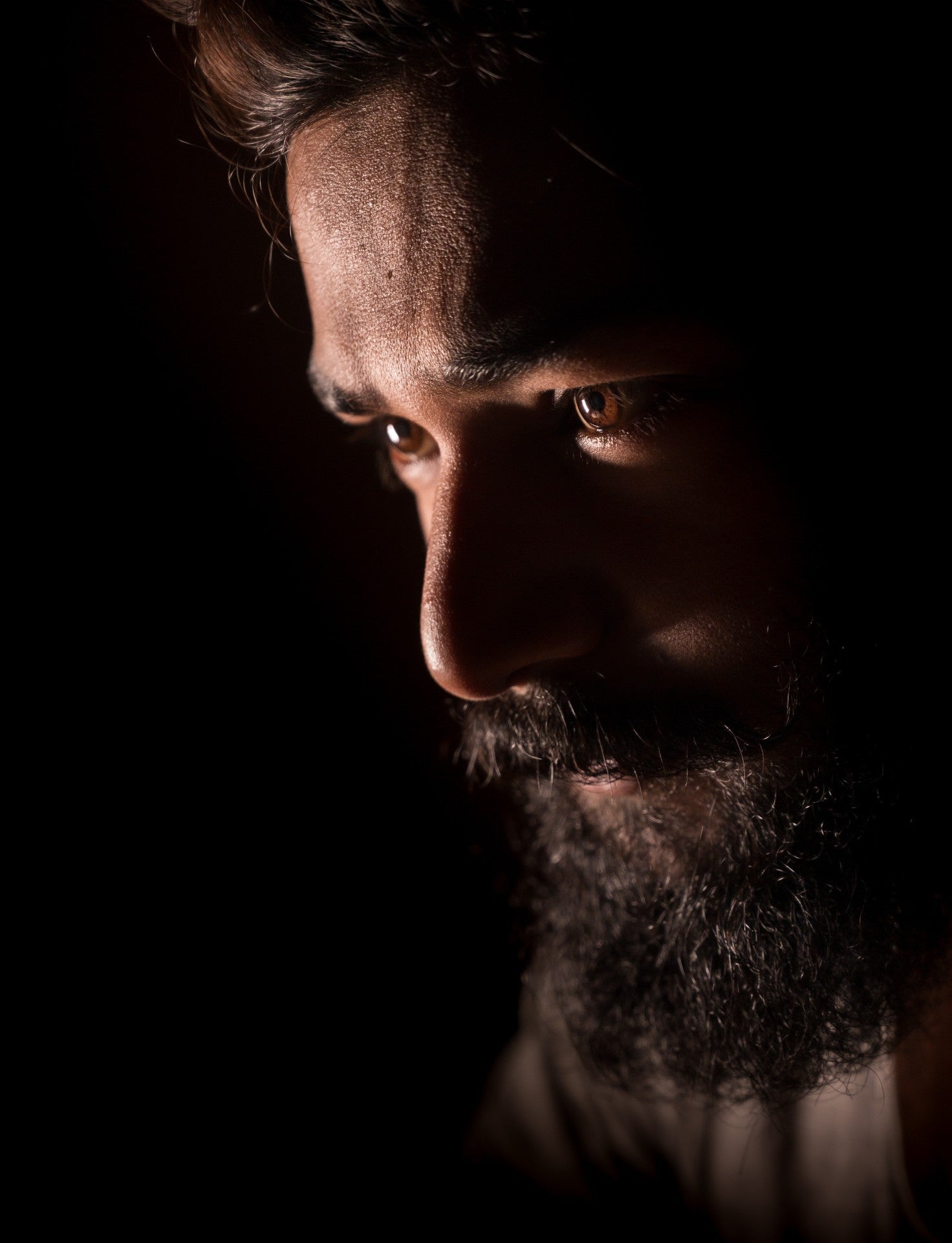 Man with beard looking intently